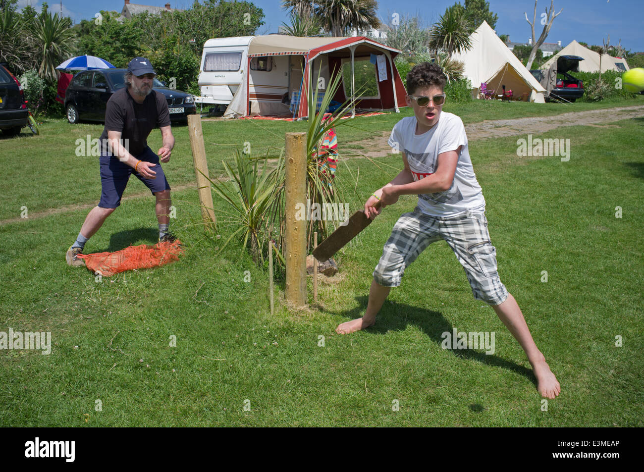 Teenage boy playing cricket, Henry's Campsite, Cornwall, England, UK Stock Photo