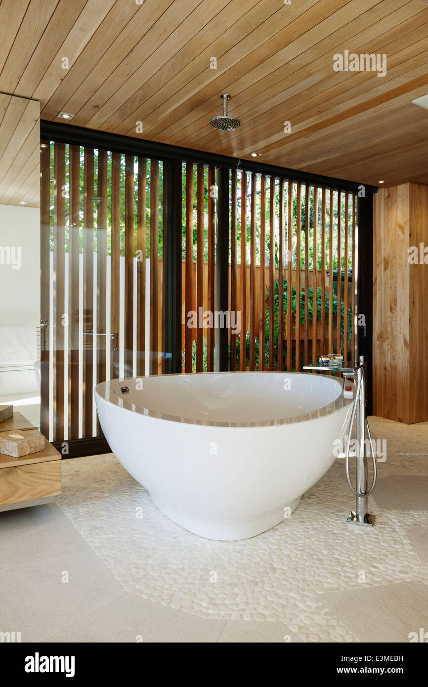Modern soaking tub in bathroom Stock Photo Alamy