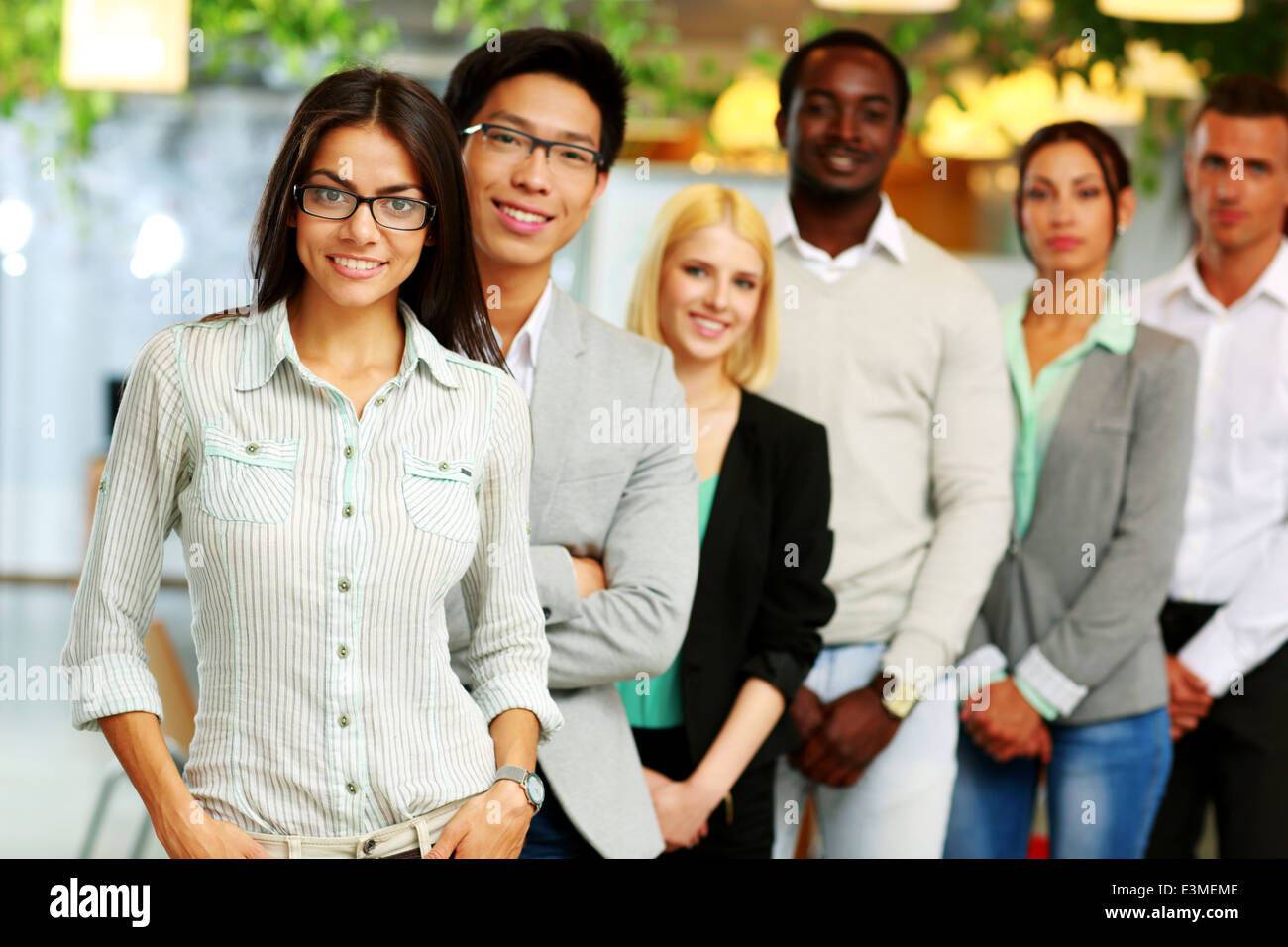 Smiling group of business people in the office lined up Stock Photo