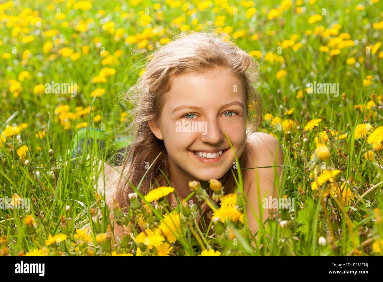 Portrait of beautiful girl in the green grass Stock Photo - Alamy