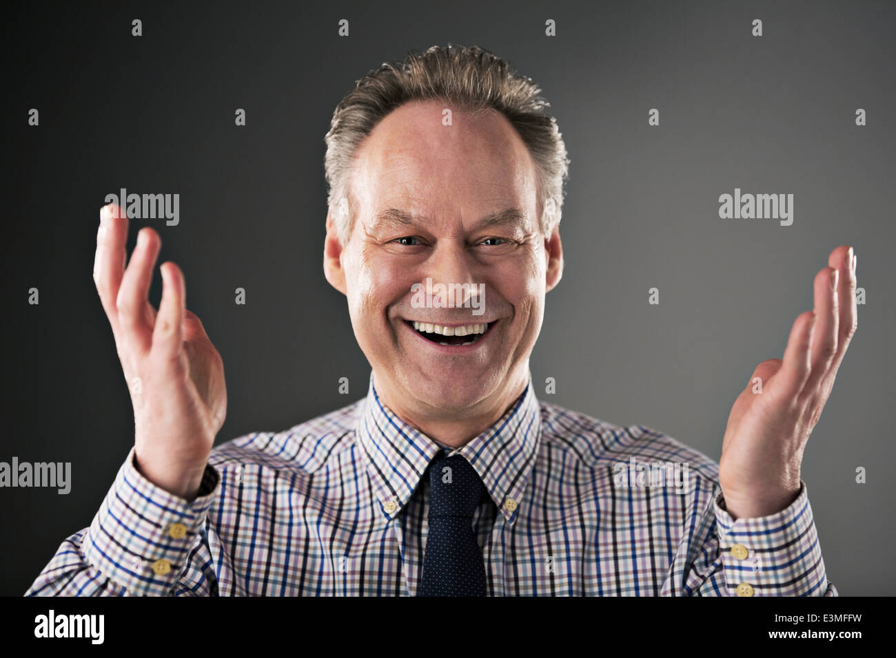 Portrait of smiling businessman gesturing Stock Photo