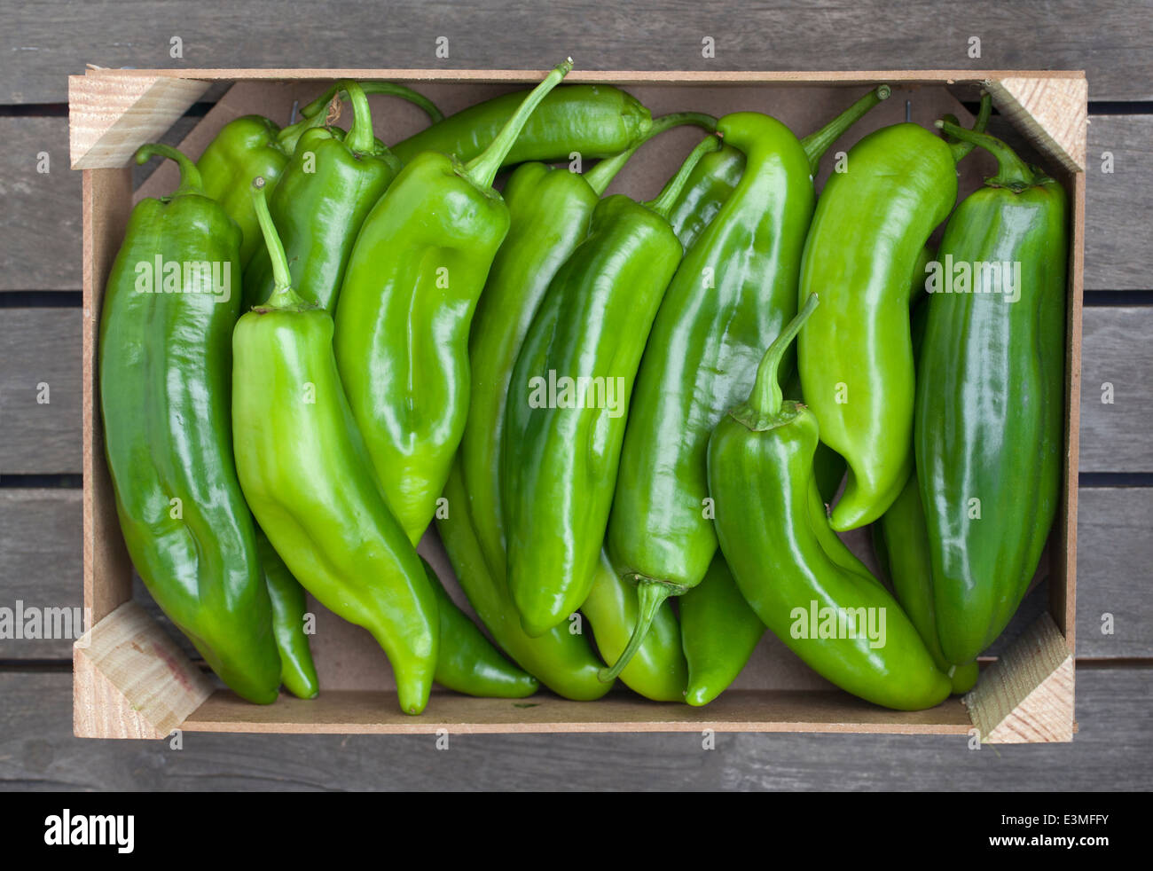 Wooden box of fresh green peppers Stock Photo