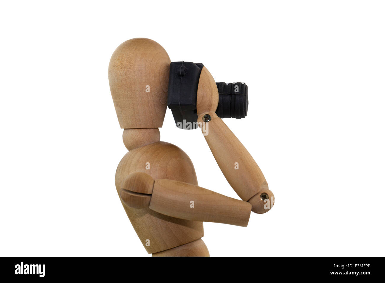 Photographer. Wooden figure taking photos with a reflex camera. Stock Photo