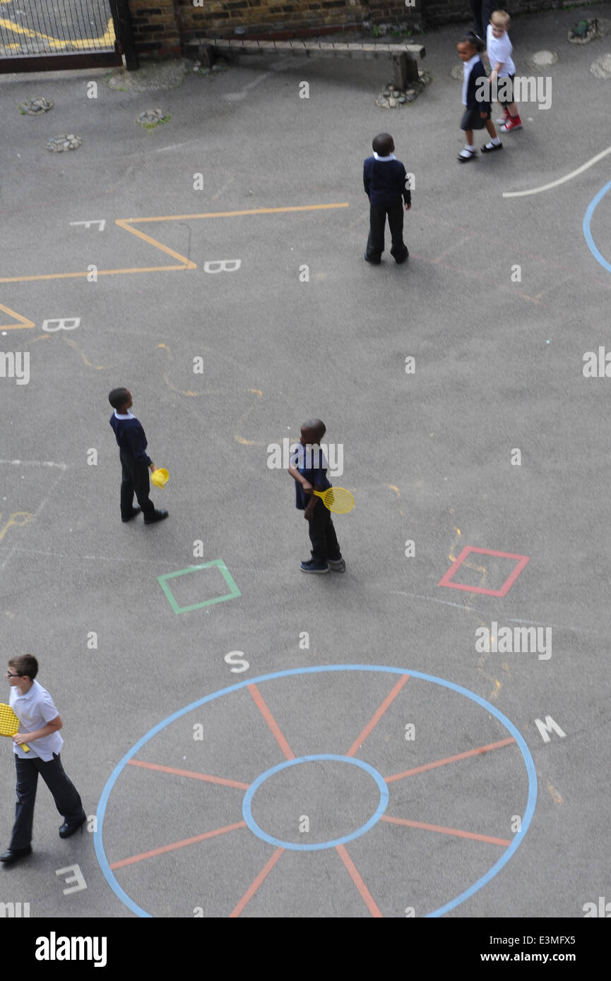 School children playing in a school playground in an inner city london primary school. Stock Photo