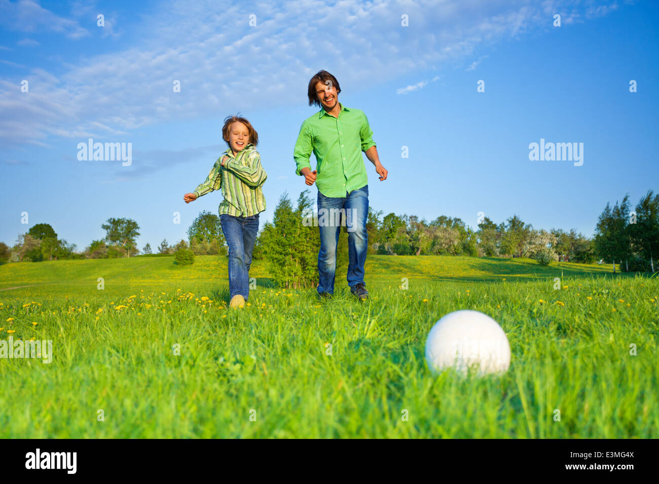 Father and kid playing football in park Stock Photo - Alamy