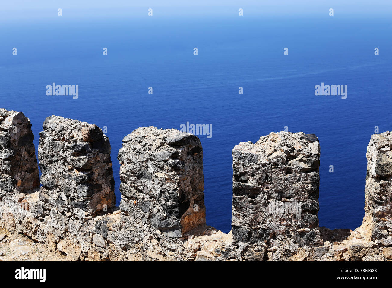 stone fence on a background of the blue sea Stock Photo