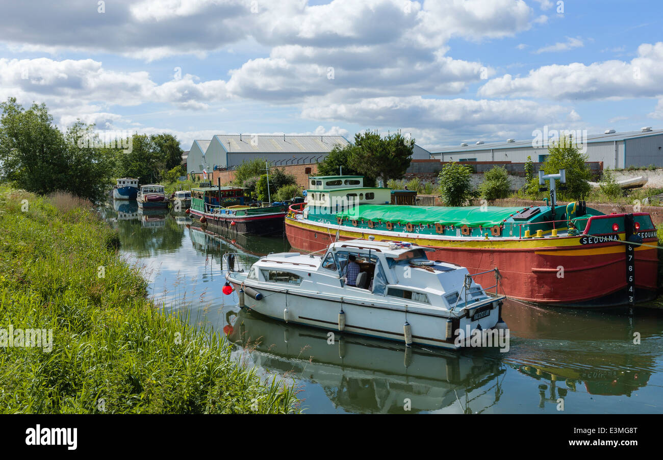 Derelict barges, river boats, and present day factories along the river Hull and its banks n Beverley, Yorkshire. Stock Photo
