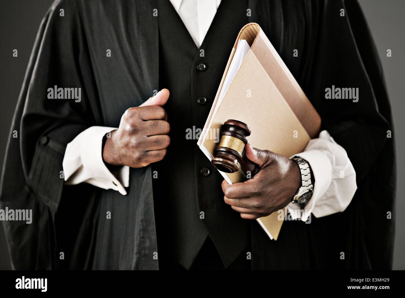 Close up of judge holding file and gavel Stock Photo