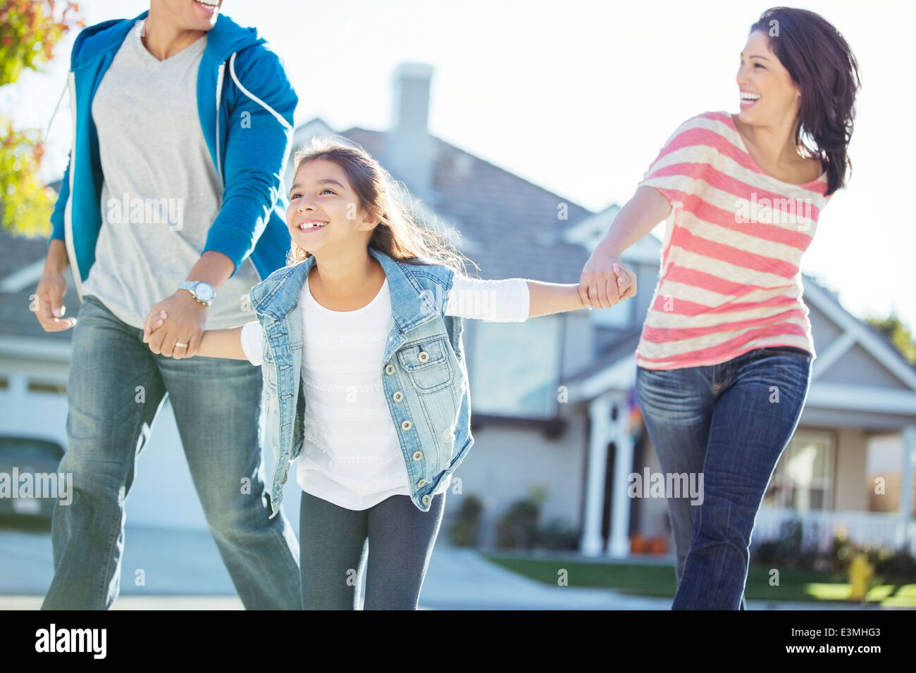 Happy family holding hands and running Stock Photo