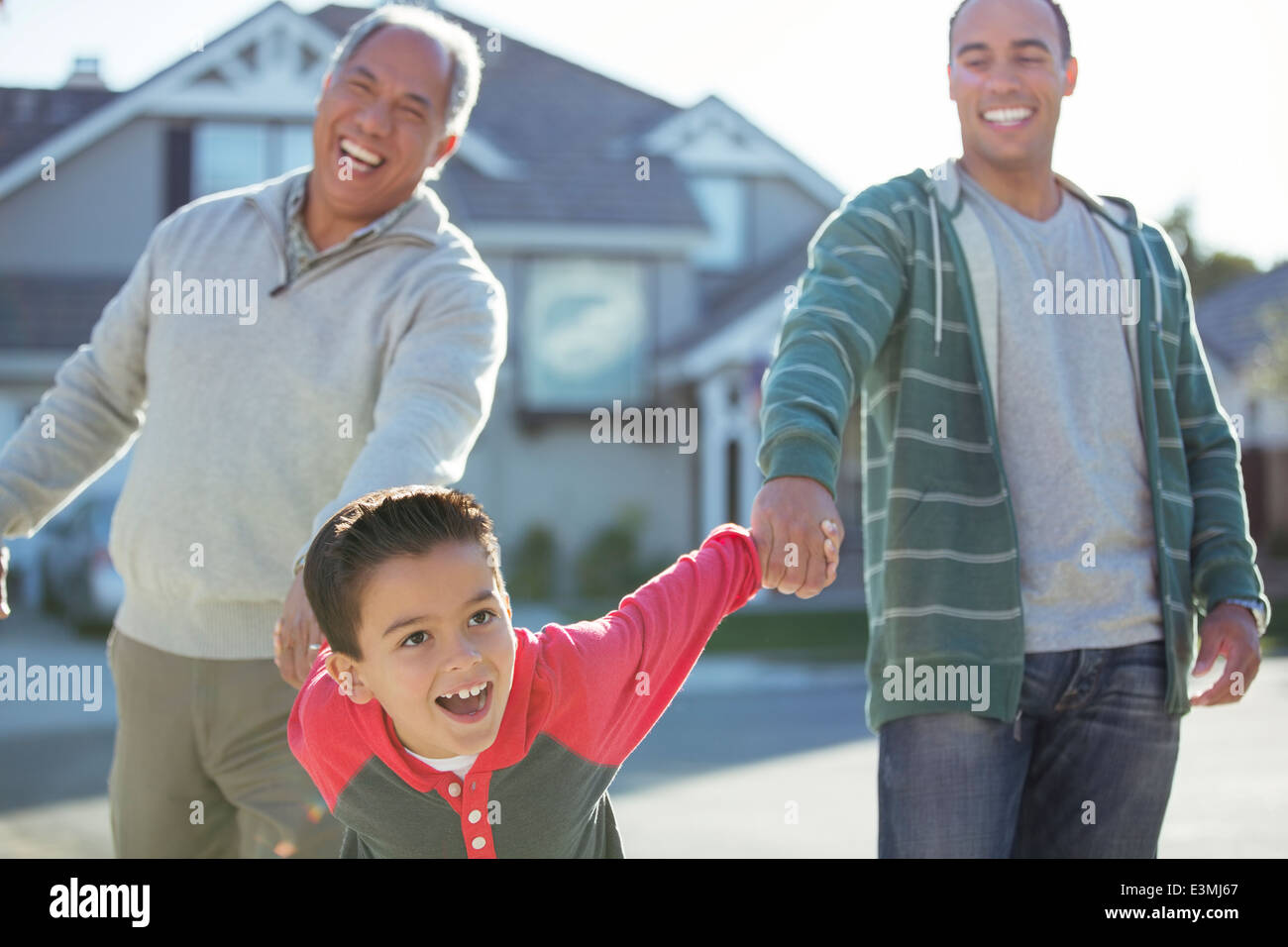 Multi-generation men laughing outdoors Stock Photo