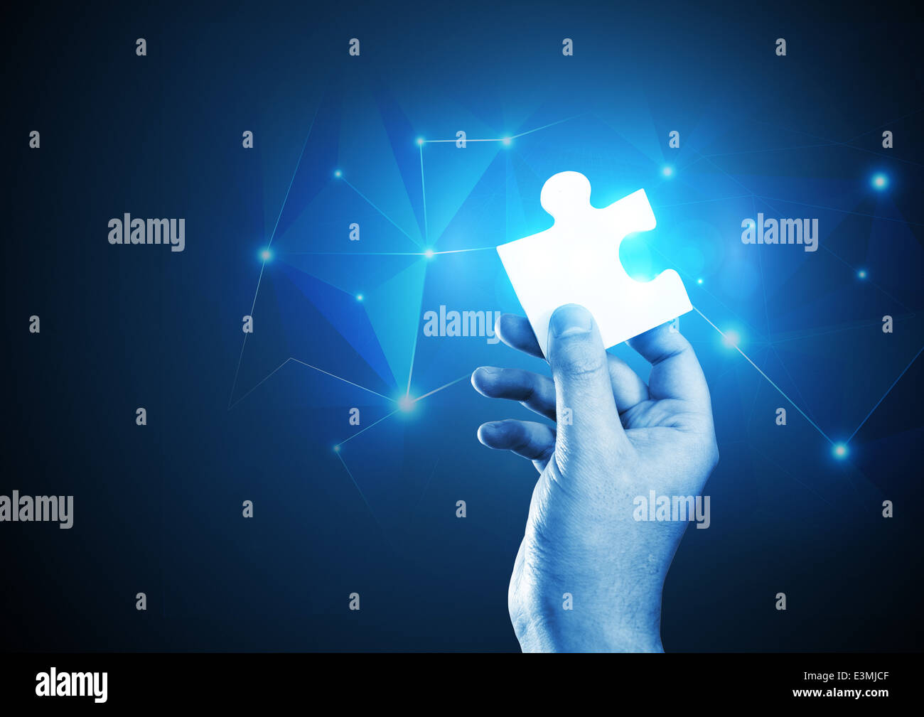 A man holding the correct piece of the puzzle. Stock Photo
