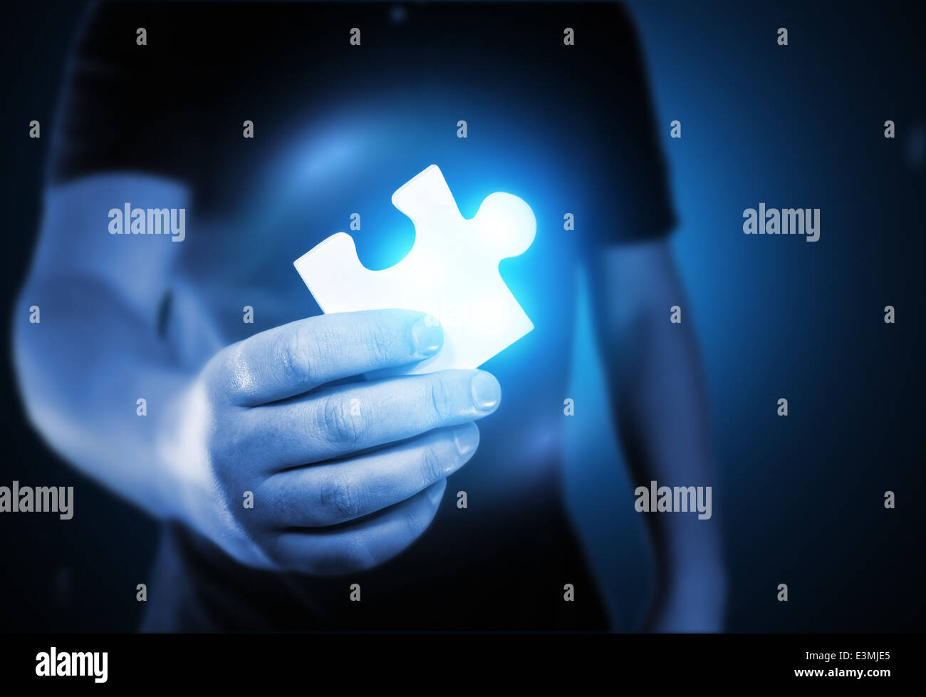A man holding the missing puzzle piece. Stock Photo
