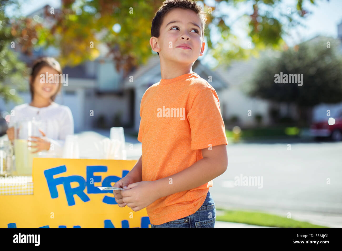 Boy buying lemonade at lemonade stand Stock Photo Alamy