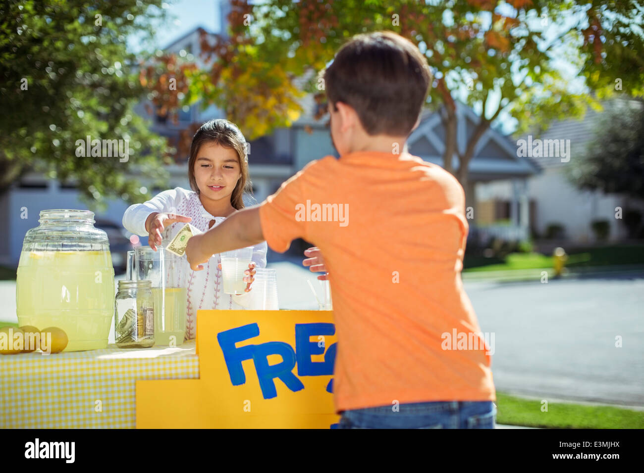Boy buying lemonade at lemonade stand Stock Photo