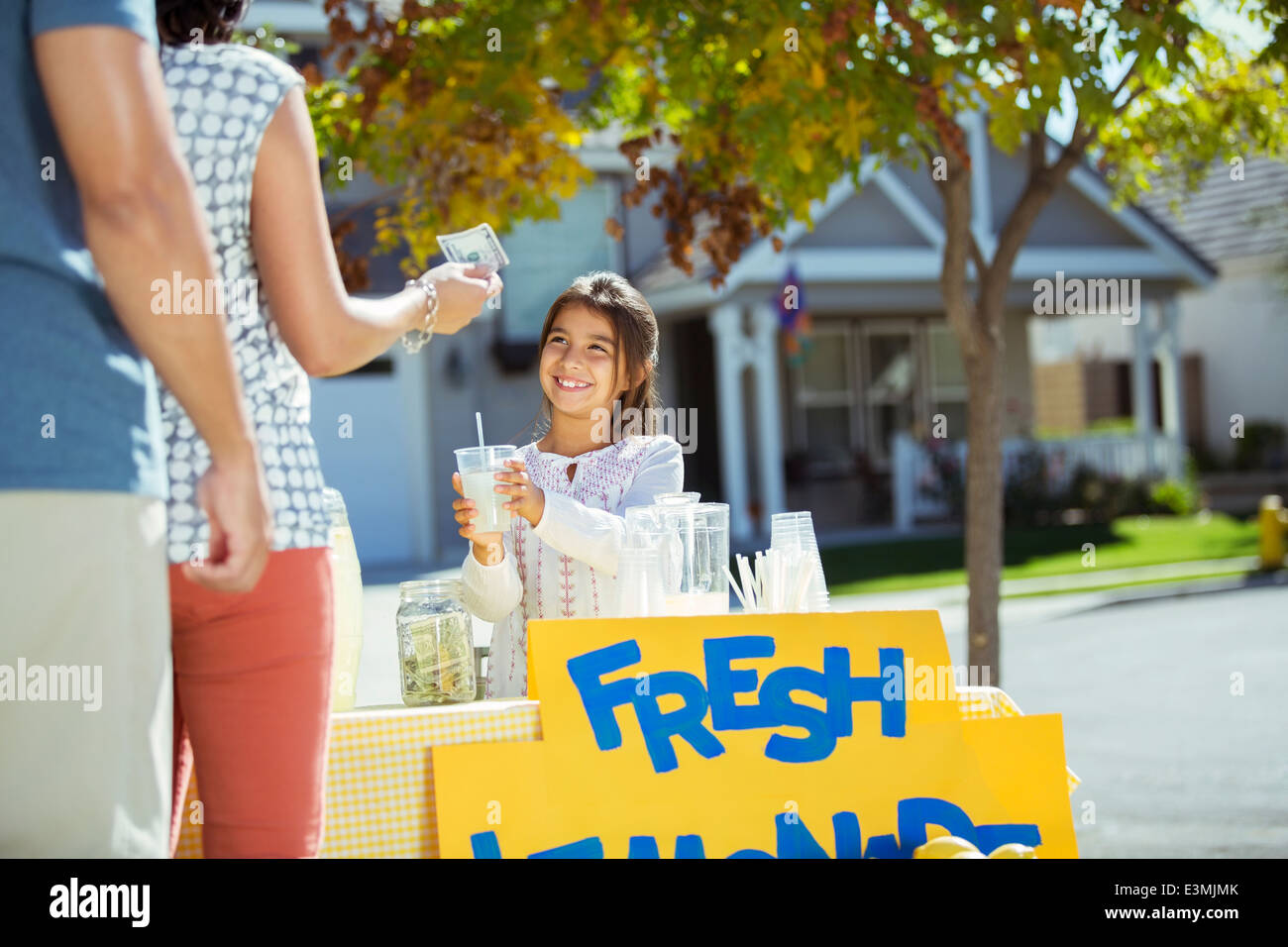 Girl selling lemonade at lemonade stand Stock Photo