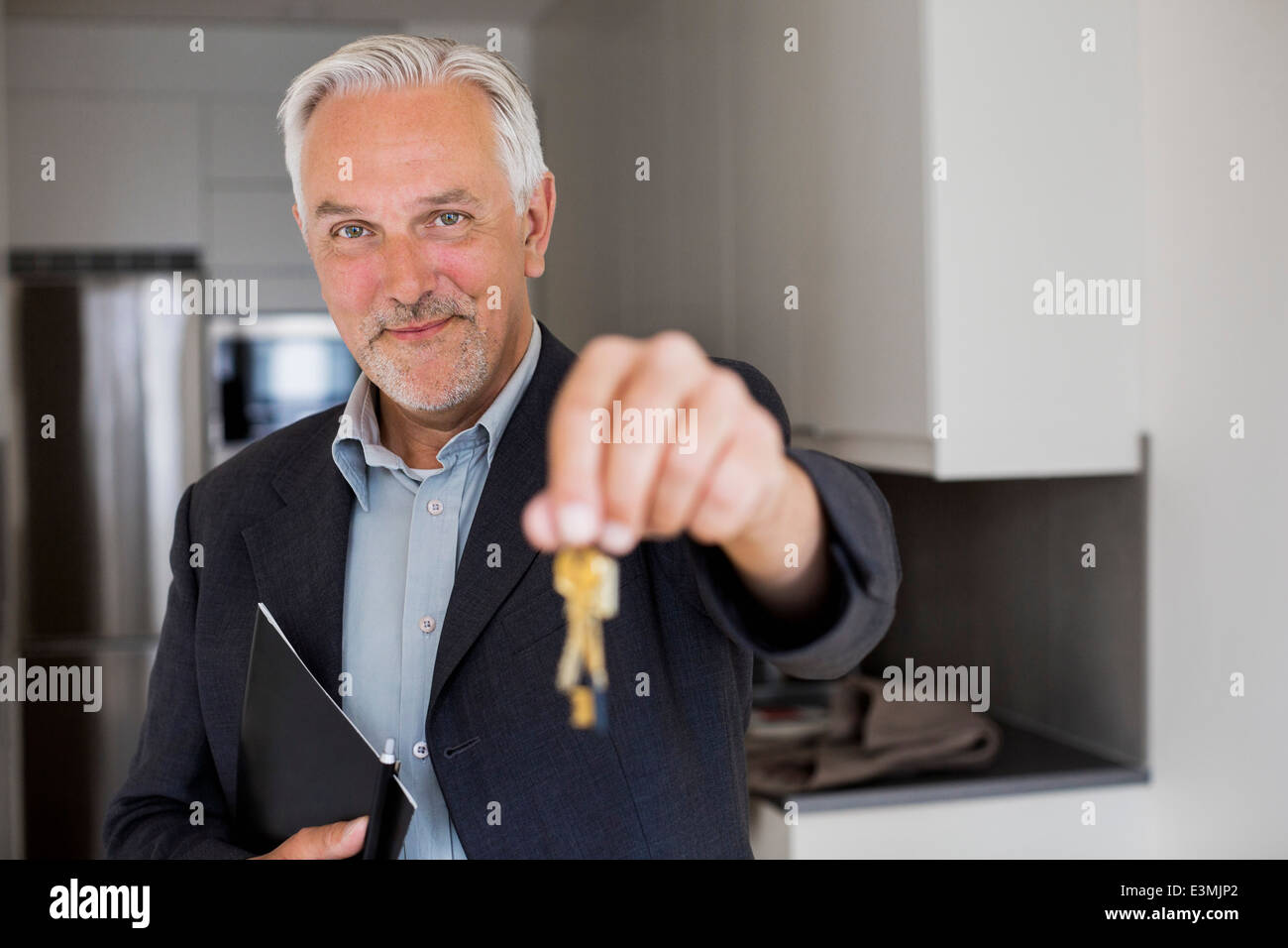 Portrait of confident real estate agent holding new house keys Stock ...