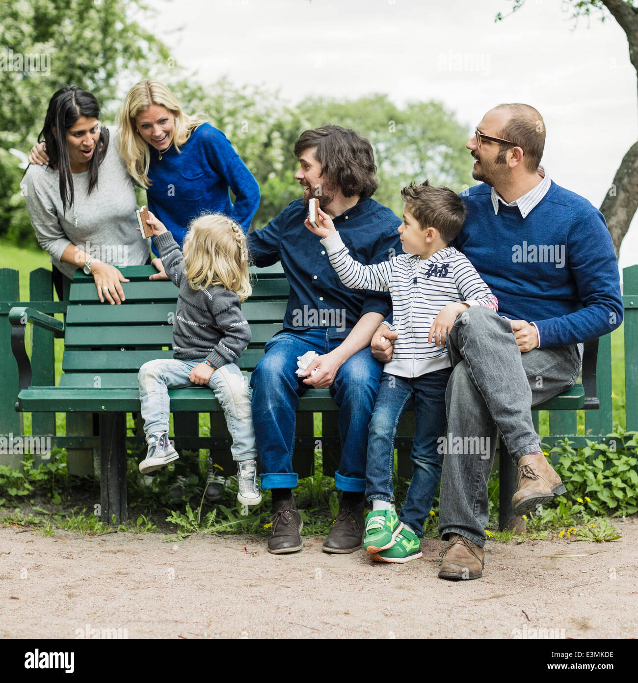 Homosexual families spending leisure time in park Stock Photo