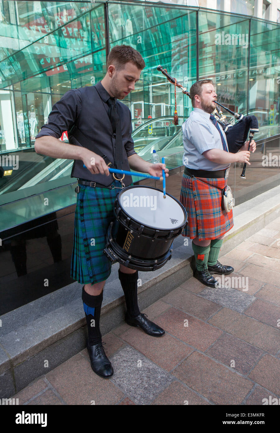 Two Scottish men playing traditional Scottish band instruments