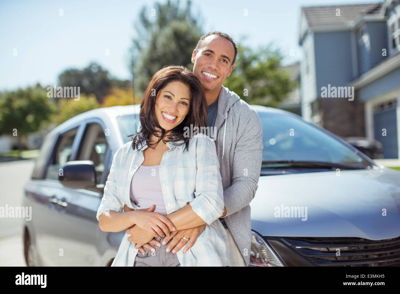 Portrait of smiling couple in driveway Stock Photo