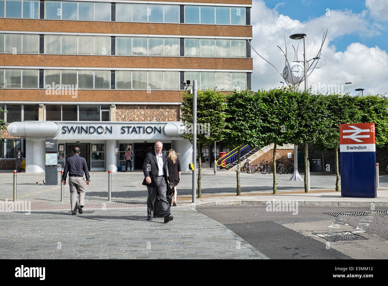 Commuters outside the railway station entrance underneath Signal Point in Swindon, Wiltshire, UK Stock Photo