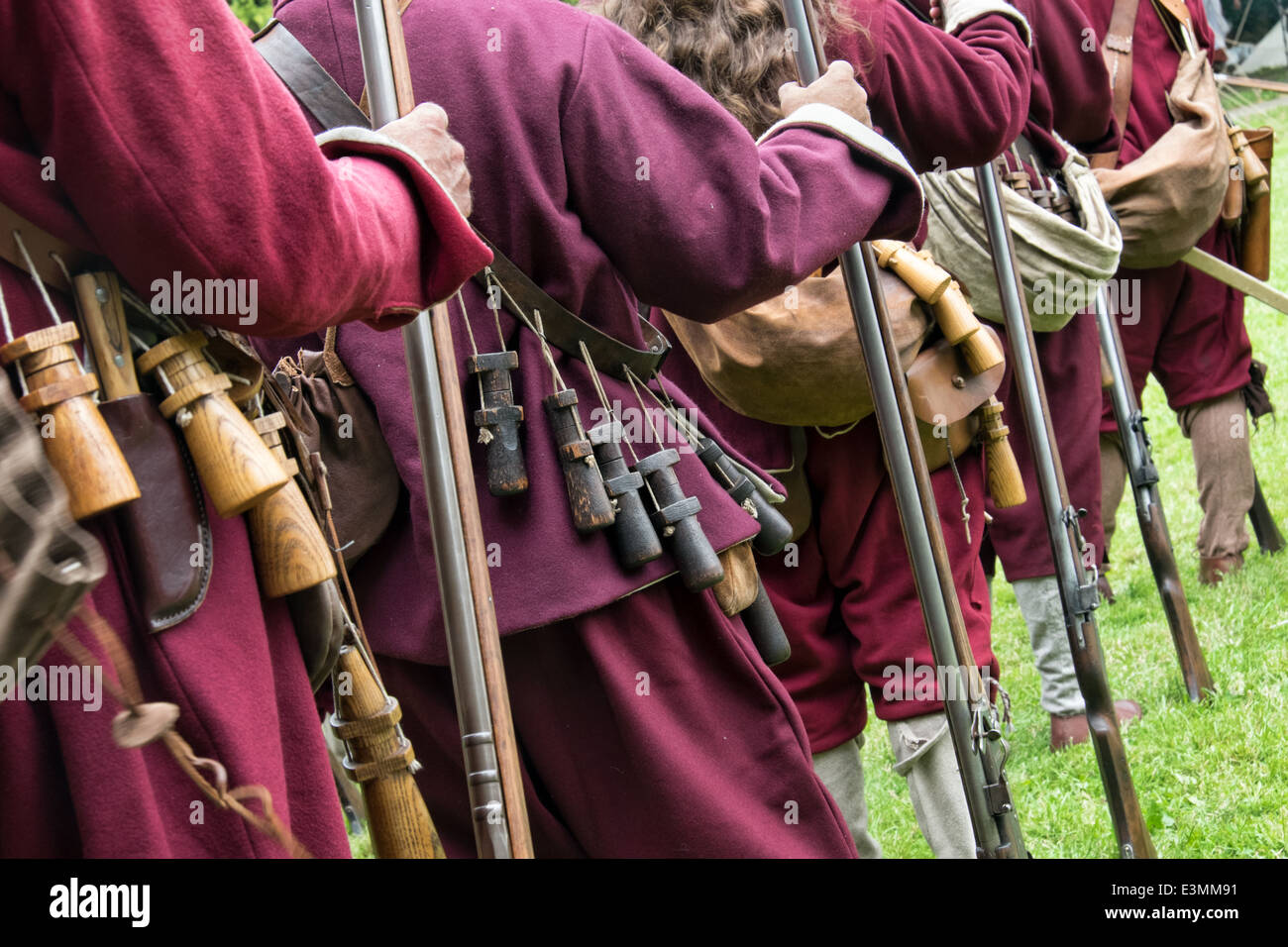 A row of Uniformed Living history reenactors portraying 17th century English civil war soldiers with equipment Stock Photo