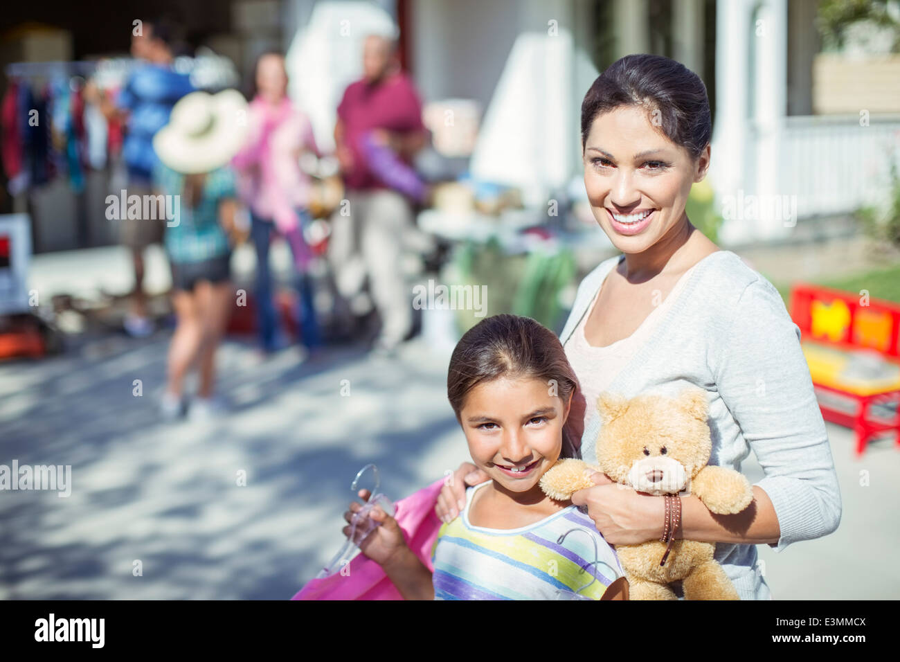 Portrait of mother and daughter shopping at yard sale Stock Photo Alamy