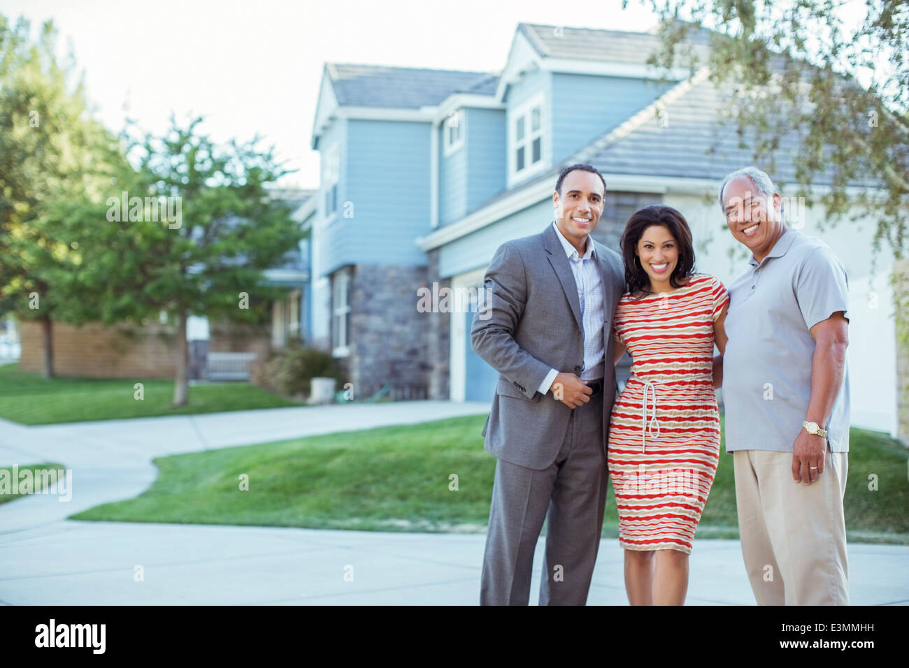 Portrait of smiling family in driveway Stock Photo