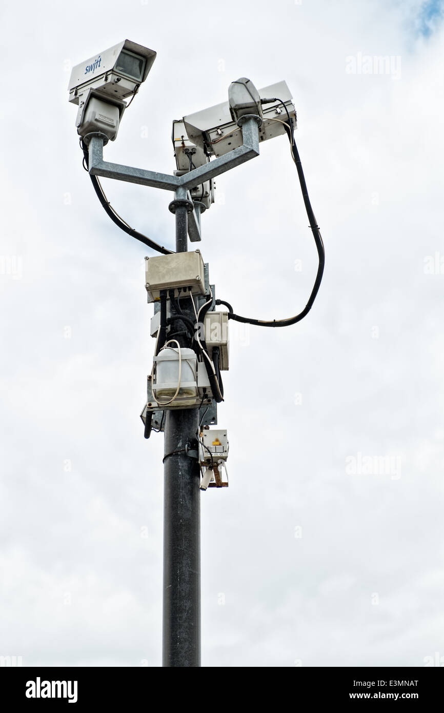 3 cctv cameras sit, big brother style, on top of a pole to provide security imaging & surveillance Stock Photo