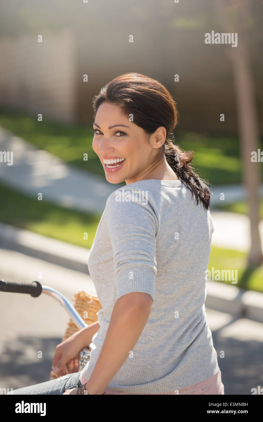 Portrait of enthusiastic woman on bicycle Stock Photo