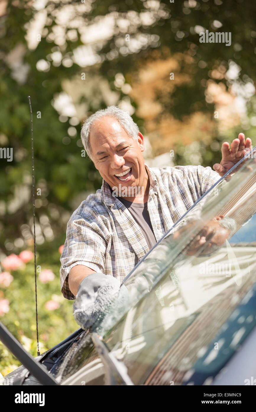 Happy man washing car Stock Photo