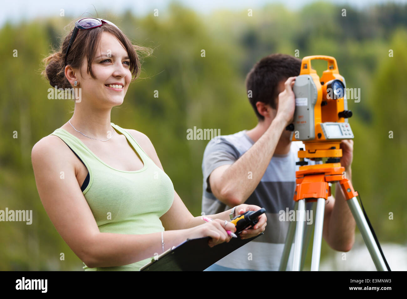 Two young land surveyors at work Stock Photo