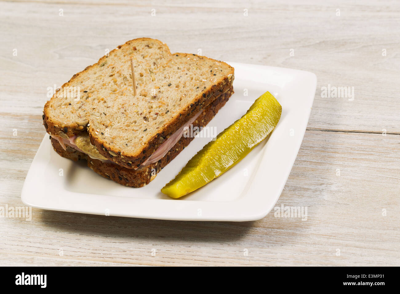 ham sandwich made with fresh whole wheat and single large sliced pickle