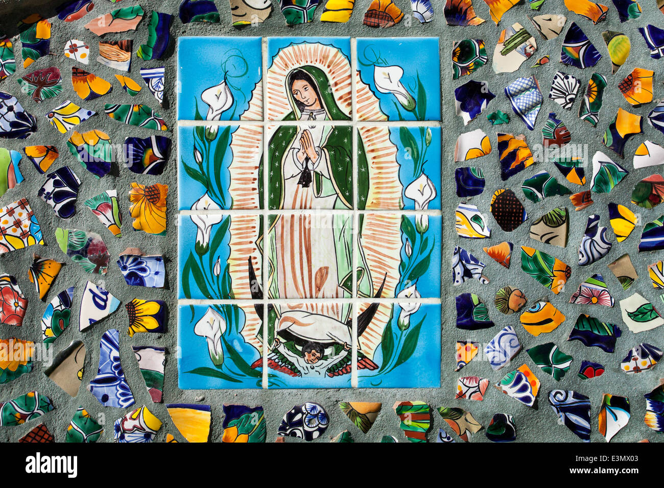 A tile painting of the Virgin of Gualalupe surrounded by broken pieces of tile set in cement, Puerto Vallarta, Jalisco, Mexico. Stock Photo