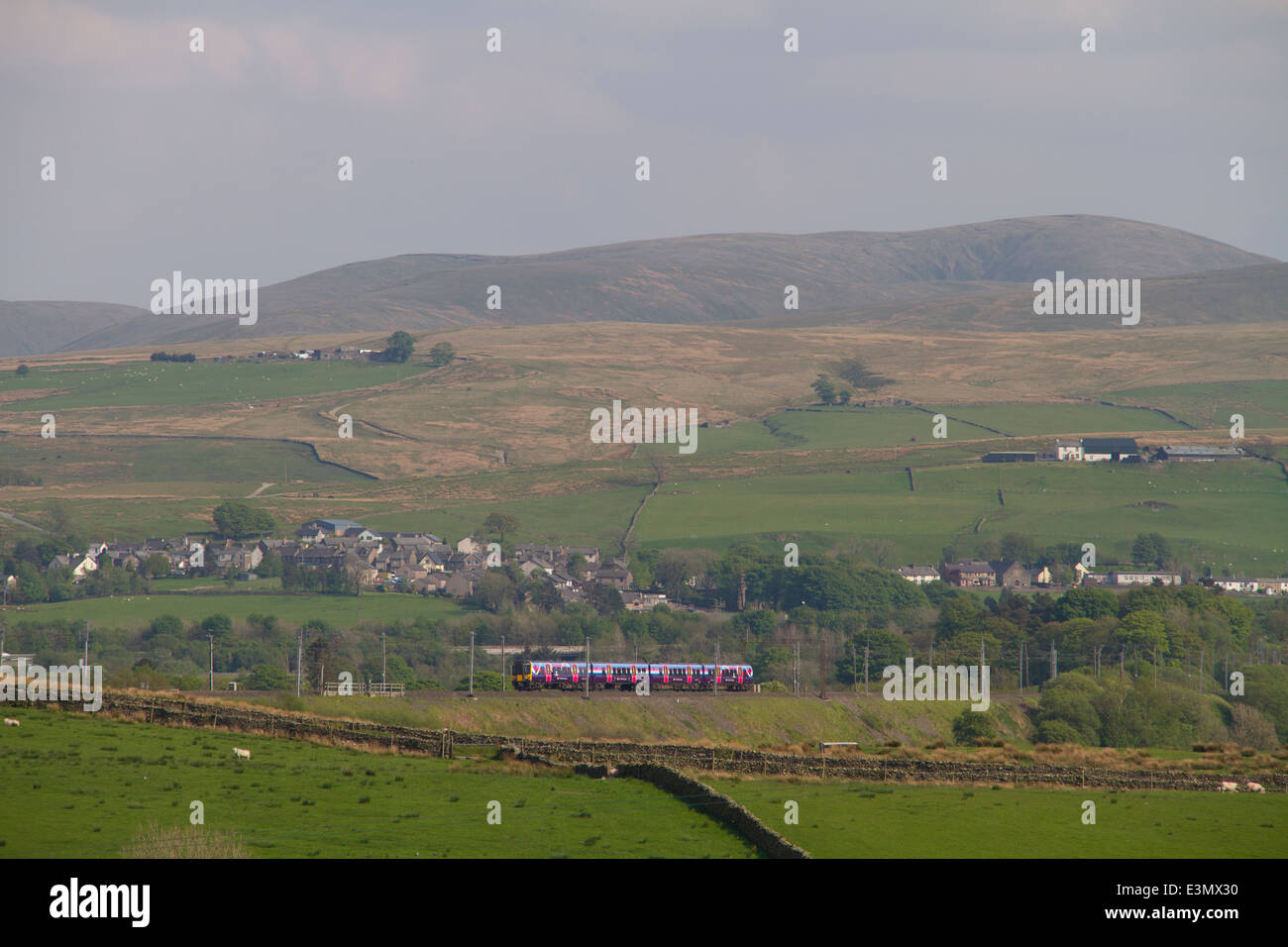 A class 350 First Transpennine Express EMU climbs past Greenholm on the ascent to Shap summit. 18th May 2014 Stock Photo
