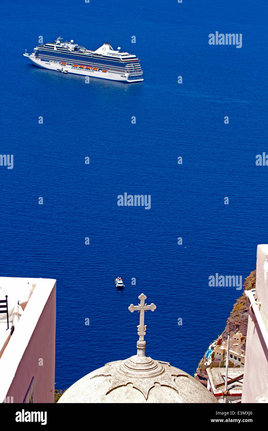 Big cruise ship,small boat and church with cross on Aegean Sea,Santorini,Greece Stock Photo