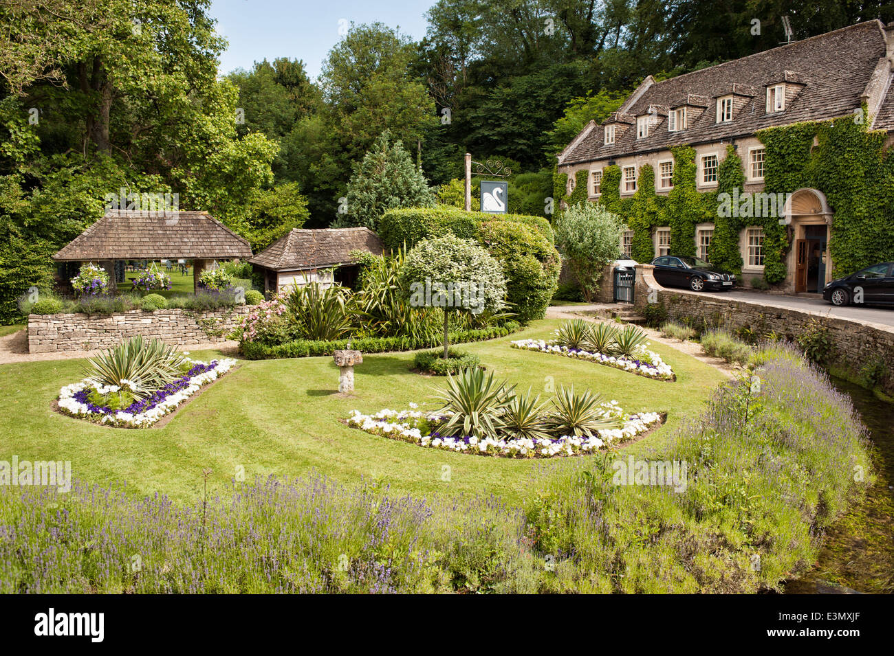 The gardens of the Swan Hotel in the Cotswold village of Bibury, Gloucestershire, UK Stock Photo