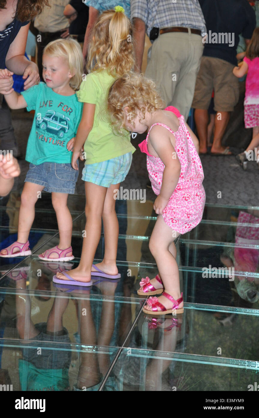 Looking at exhibit beneath glass floor Stock Photo Alamy