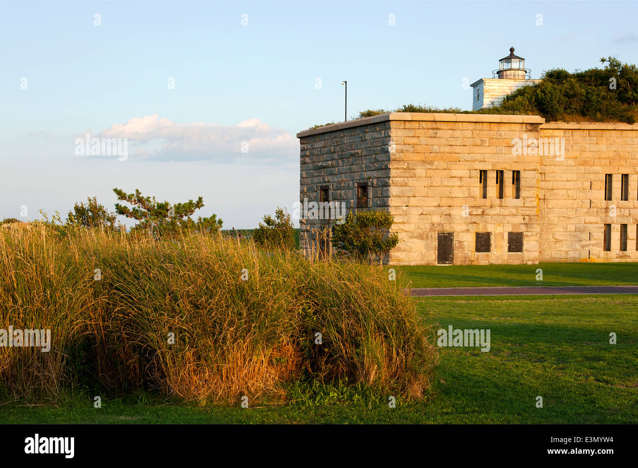 Sun sets behind Clark's Point lighthouse as it sits atop Fort Taber