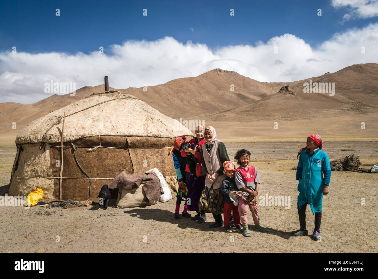 Tajik family near their yurt, Pamir highway, Tajikistan, Asia Stock Photo