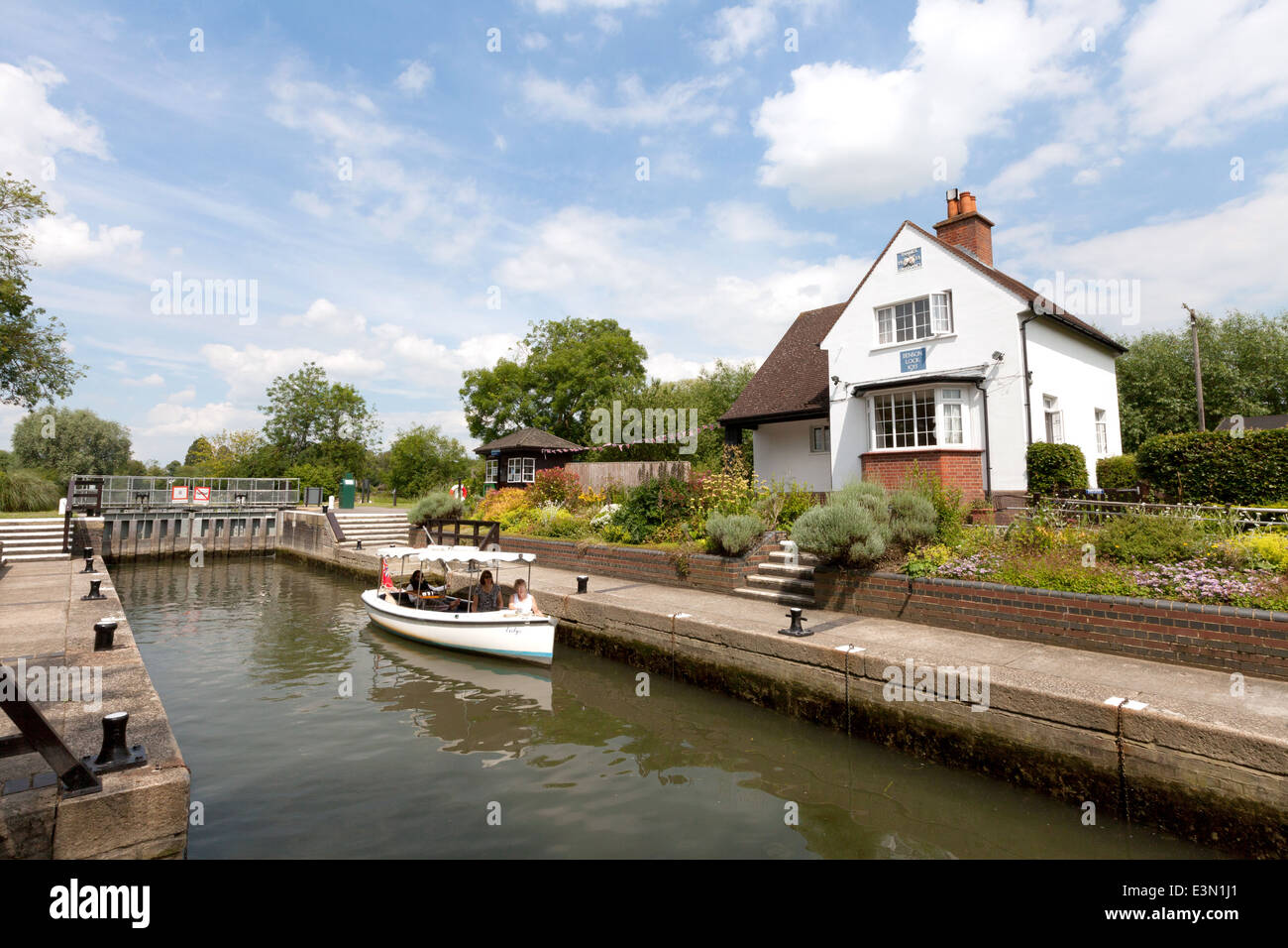 A boat in Benson Lock, with the lock house, River Thames, Benson