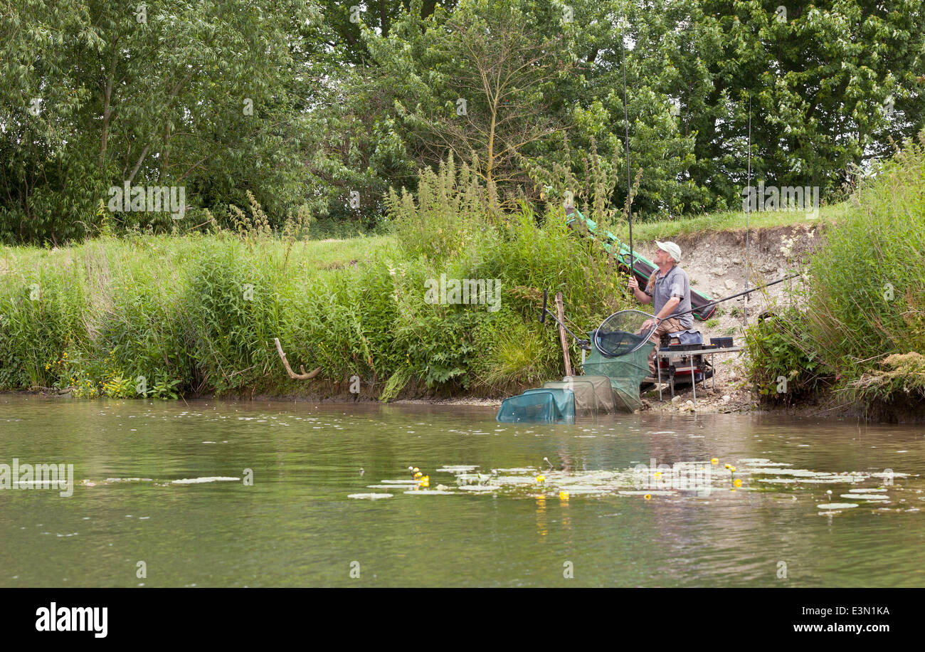Fisherman fishing on the bank of the River Thames at Wallingford, Oxfordshire England UK Stock Photo