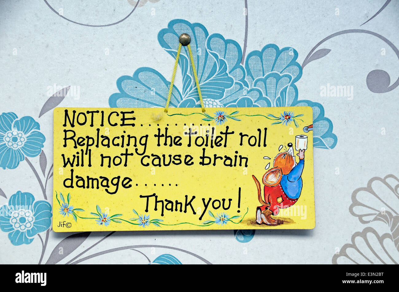 Sign inside lavatory saying replacing the toilet roll will not cause brain damage Stock Photo