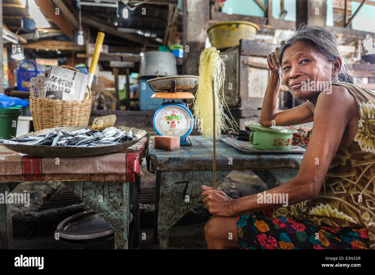 Woman selling fish in a rural market, Philippines Stock Photo