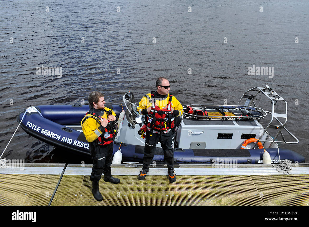 Crew members of the emergency Foyle Search And Rescue, wearing life jackets, on duty at the River Foyle, Derry, Londonderry Stock Photo