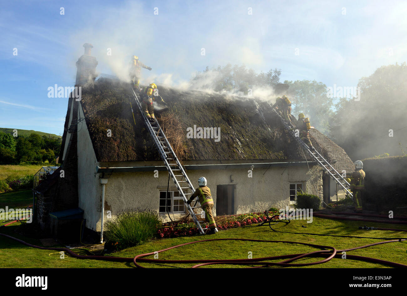 Thatched cottage fire, firefighters at a thatched cottage fire, UK