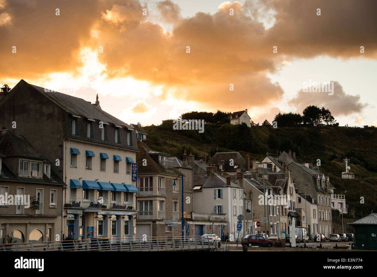 Dramatic light on clouds at sunrise. Port en Bessin, Calvados, Normany, France. Stock Photo