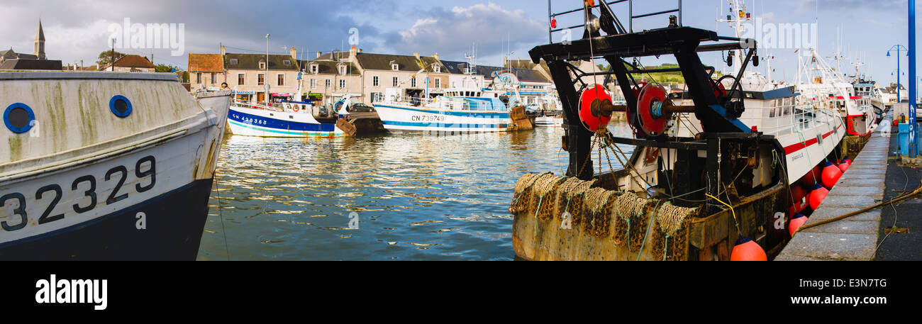 Commercial fishing boats docked along the quay in Port-en-Bessin, Normandy, France Stock Photo