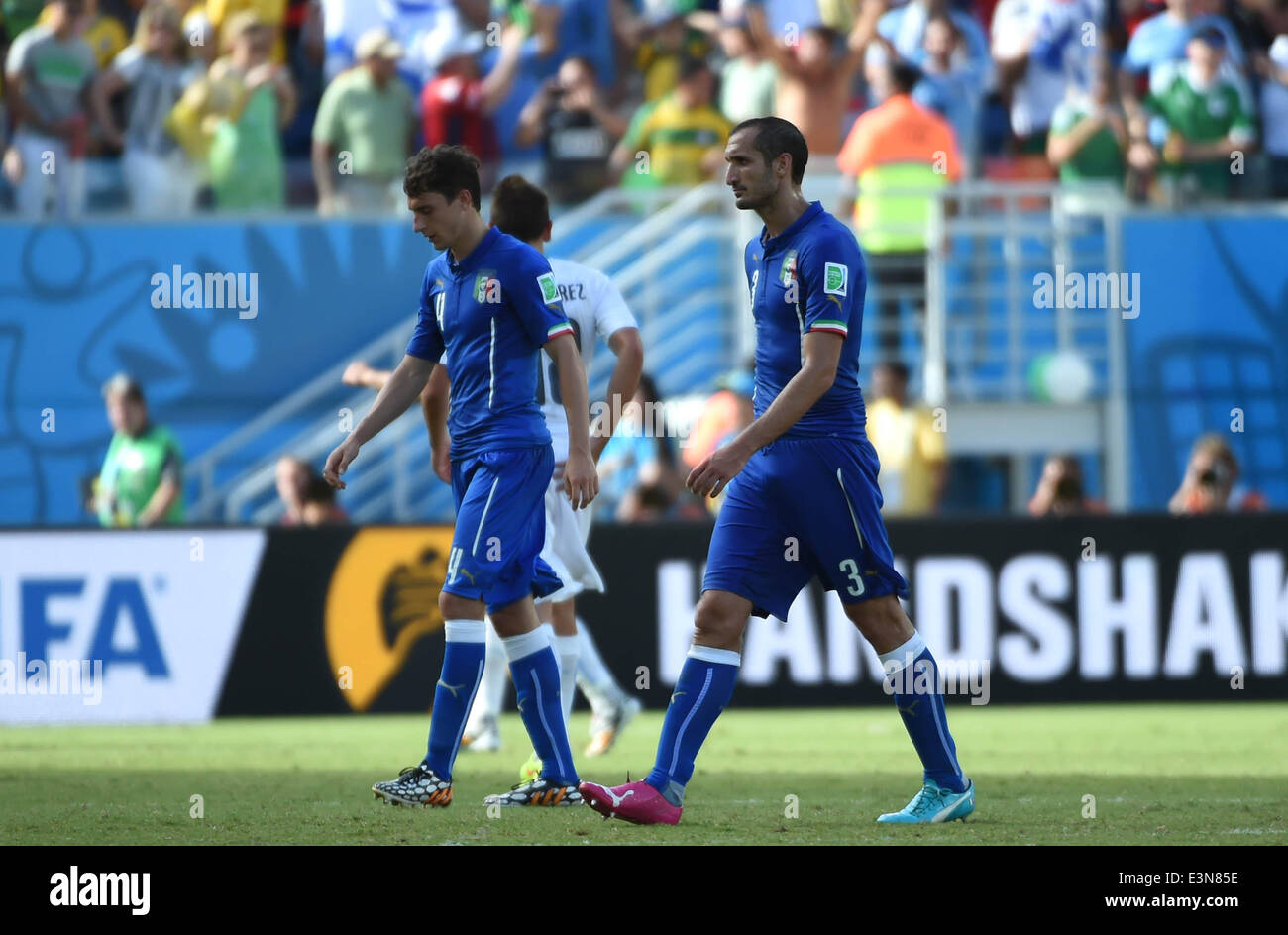 Natal, Brazil. 24th June, 2014. Italy's Giorgio Chiellini (R) leaves the field after a Group D match between Italy and Uruguay of 2014 FIFA World Cup at the Estadio das Dunas Stadium in Natal, Brazil, June 24, 2014. Uruguay won 1-0 over Italy on Tuesday. © Guo Yong/Xinhua/Alamy Live News Stock Photo