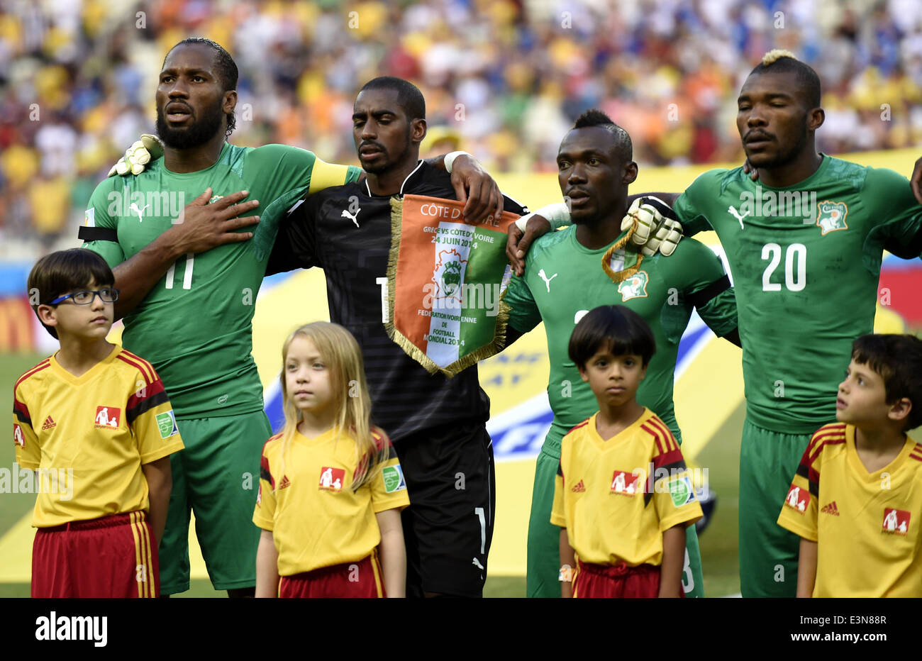 Fortaleza, Brazil. 24th June, 2014. Cote d'Ivoire's players Didier Drogba, Boubacar Barry, Arthur Boka and Geoffroy Serey Die (L to R, back) sing the national anthem prior to a Group C match between Greece and Cote d'Ivoire of 2014 FIFA World Cup at the Estadio Castelao Stadium in Fortaleza, Brazil, June 24, 2014. Credit:  Yang Lei/Xinhua/Alamy Live News Stock Photo