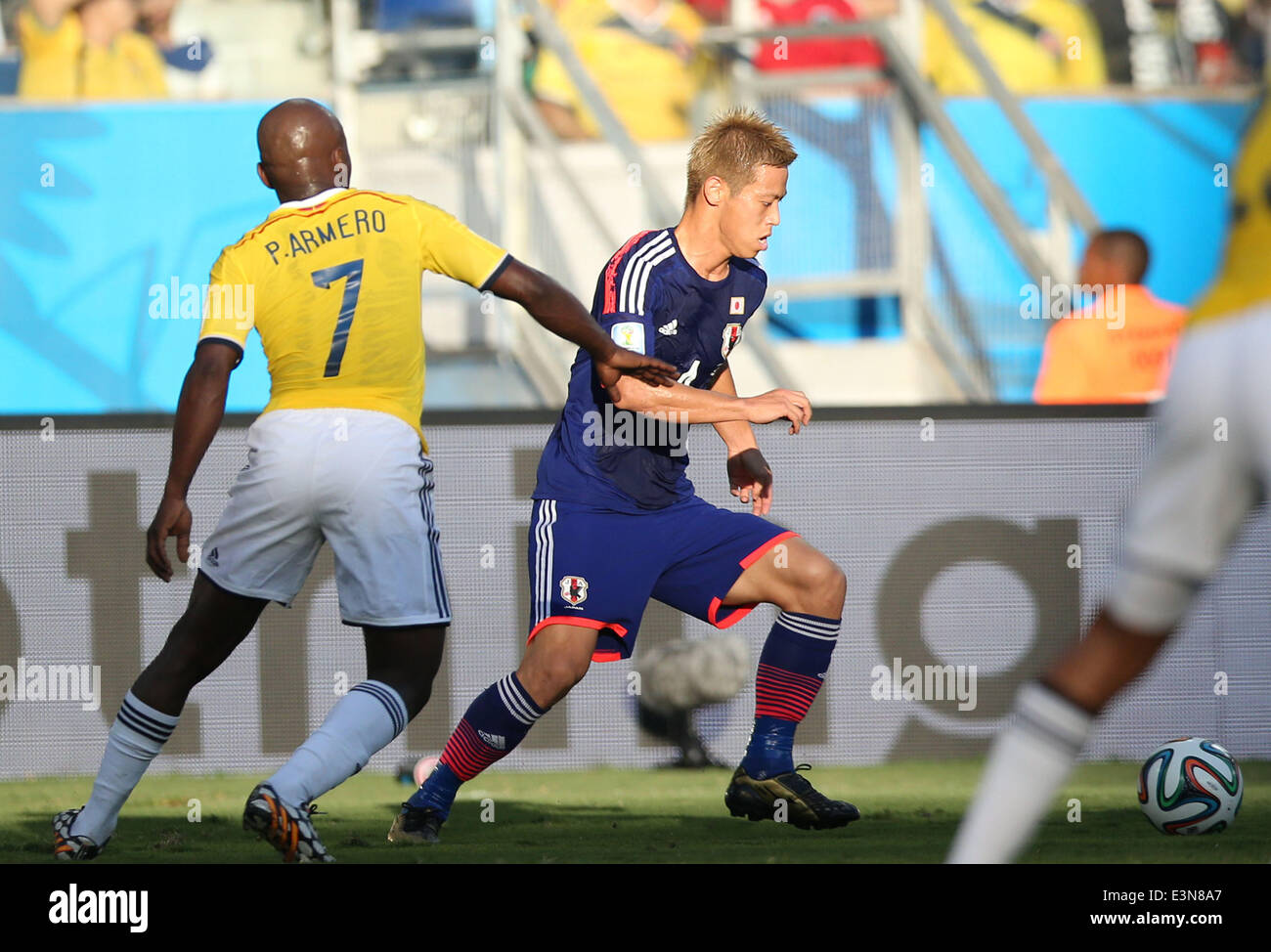 Cuiaba, Brazil. 24th June, 2014. Japan's Keisuke Honda vies with Colombia's Pablo Armero during a Group C match between Japan and Colombia of 2014 FIFA World Cup at the Arena Pantanal Stadium in Cuiaba, Brazil, June 24, 2014. © Li Ming/Xinhua/Alamy Live News Stock Photo